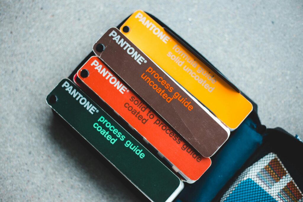 Knowledge Top view of Pantone color guides showcasing vibrant shades for creative design projects.